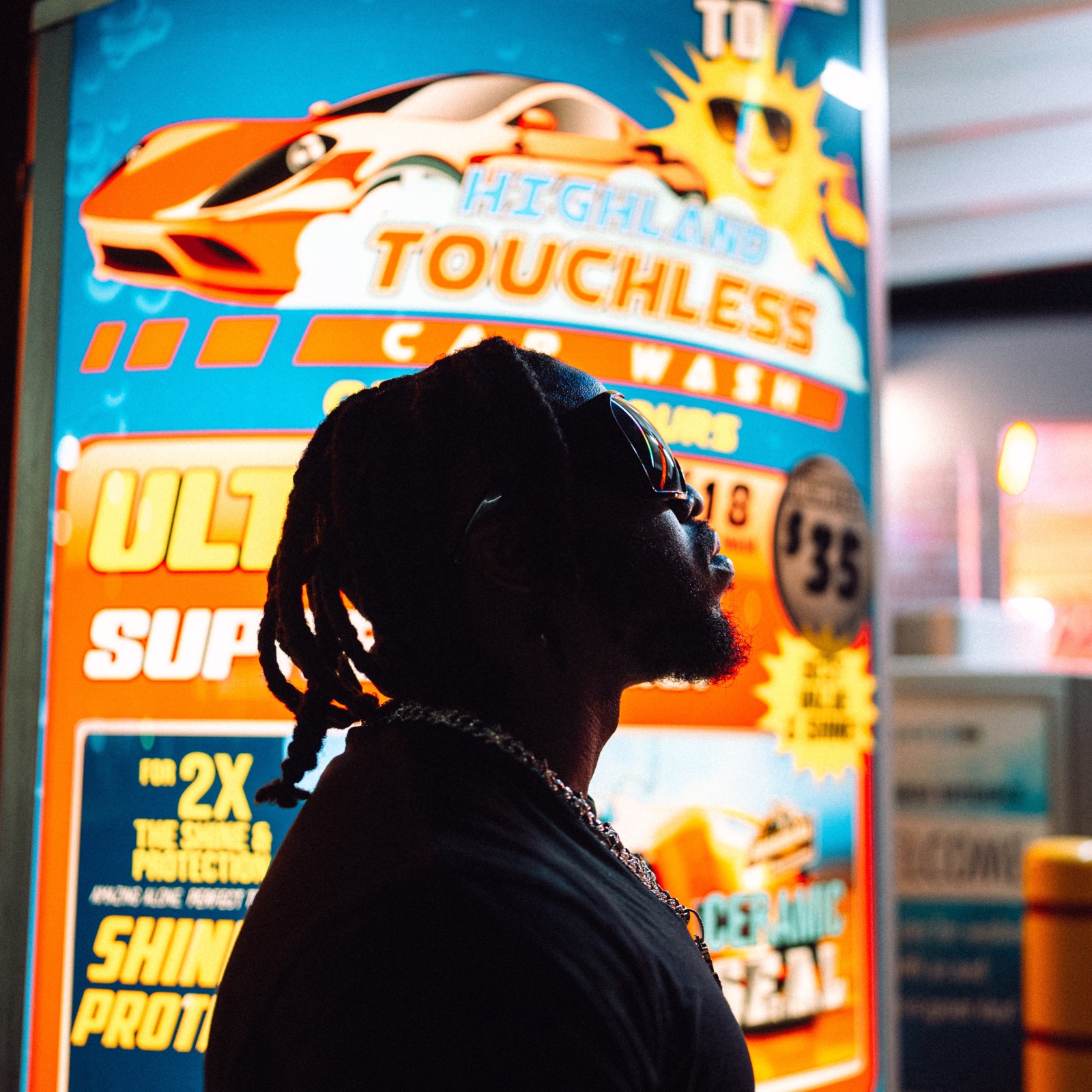 Errol Allen photographed beneath neon light