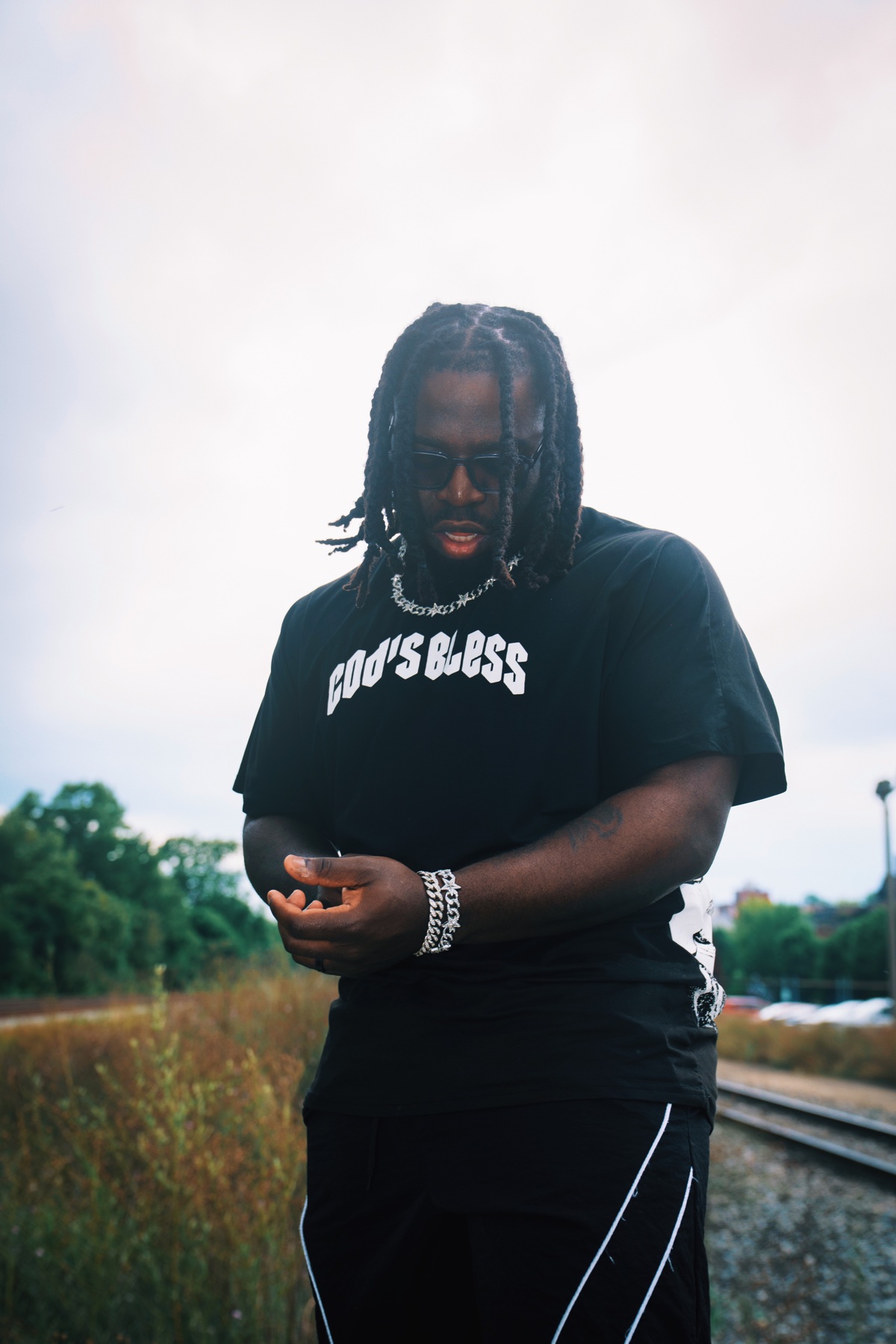 Errol Allen standing beside railroad tracks